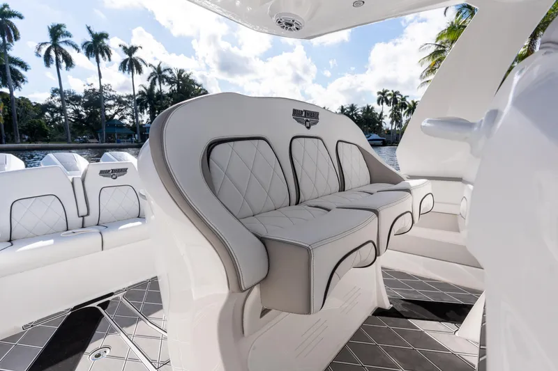 Slide: The Image of Four powerful outboard engines on a 2026 Deep Impact 399 Sport boat, docked near tropical scenery. - 26