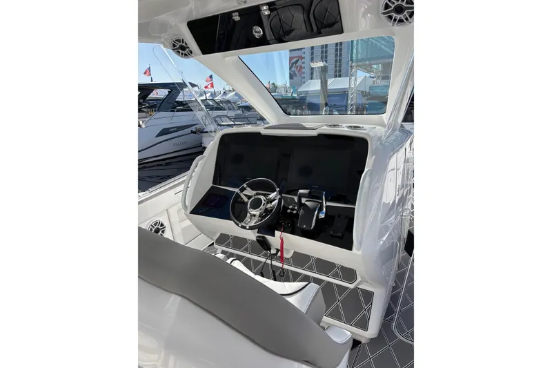 Slide: The Image of 2026 Deep Impact 399 Sport boat cruising on a sunny waterway with palm trees. - 5