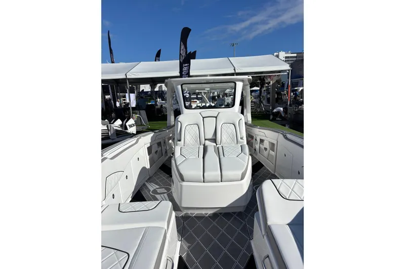 Slide: The Image of 2026 Deep Impact 399 Sport boat on water, showcasing sleek design and luxurious seating. - 9