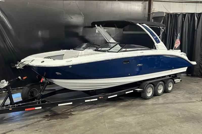 The Image of 2024 Sea Ray SDX 290 boat on trailer in indoor setting. - 1