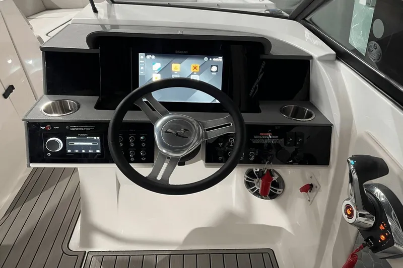 Slide: The Image of 2024 Sea Ray SDX 290 helm with steering wheel, touchscreen, and control panel. - 11