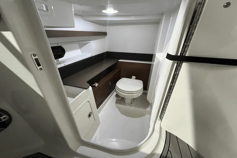 Slide: The Image of 2024 Sea Ray SDX 290 boat interior bathroom with modern amenities and sleek design. - 15