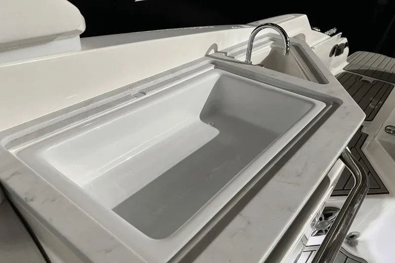 Slide: The Image of 2024 Sea Ray SDX 290 boat sink and faucet detail. - 17