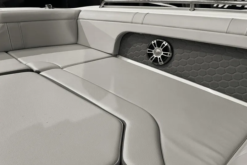 Slide: The Image of 2024 Sea Ray SDX 290 boat interior with gray seating and speaker detail. - 21