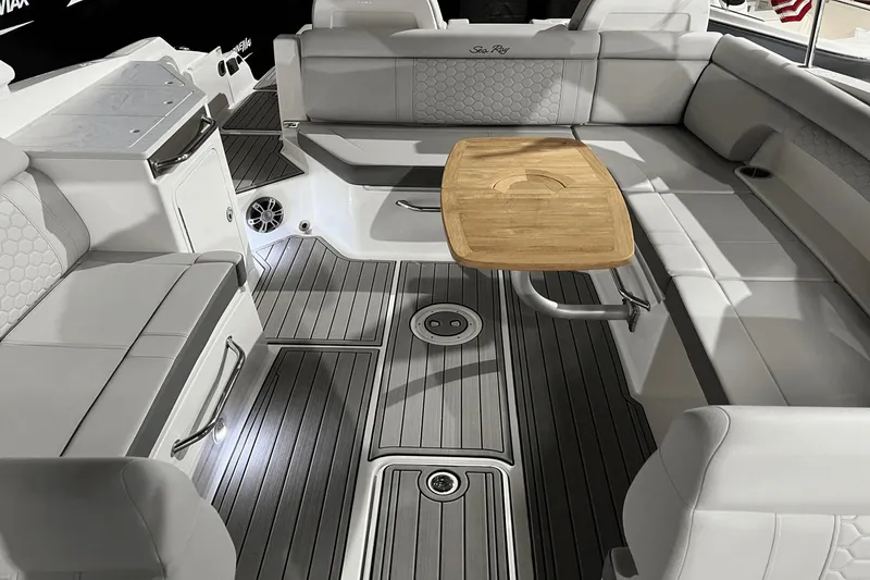 Slide: The Image of 2024 Sea Ray SDX 290 boat interior with elegant seating and wooden table. - 23