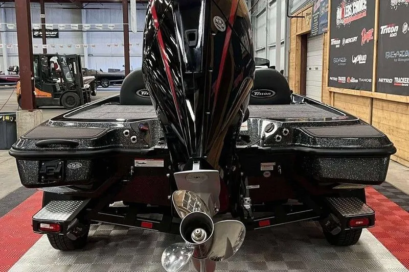 Slide: The Image of 2026 Triton 20XP Patriot boat in showroom, rear view with powerful engine. - 4