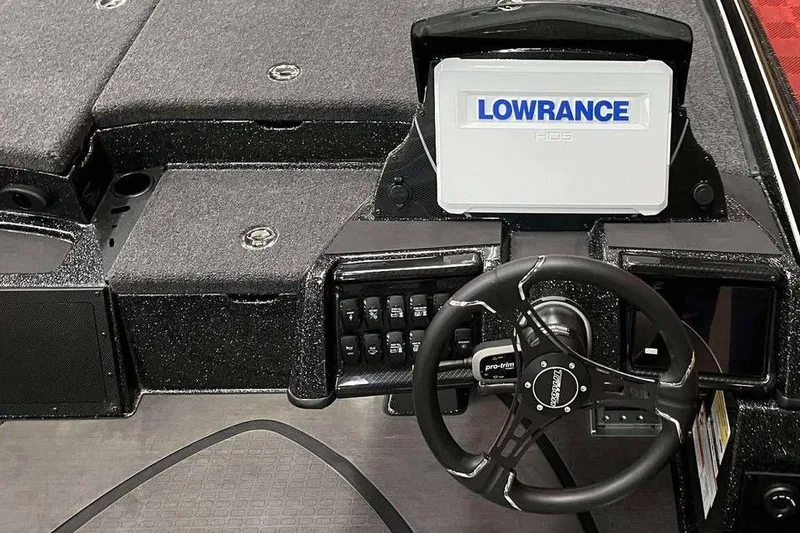 Slide: The Image of 2026 Triton 20XP Patriot boat dashboard with Lowrance display and steering wheel. - 6