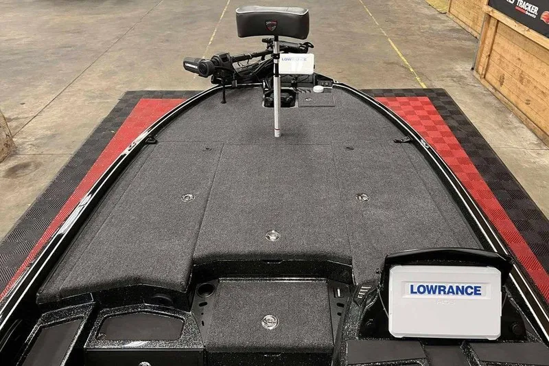 Slide: The Image of 2026 Triton 20XP Patriot boat deck with Lowrance electronics and fishing equipment. - 7