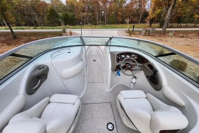 Slide: The Image of 2008 Crownline 270 BR boat interior with white seating and dashboard view. - 10