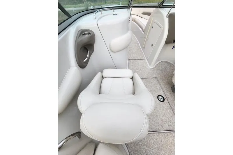 Slide: The Image of 2008 Crownline 270 BR boat interior with white seating and carpeted flooring. - 12