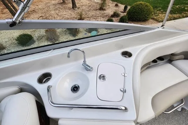 Slide: The Image of 2008 Crownline 270 BR boat interior with sink and seating area. - 14