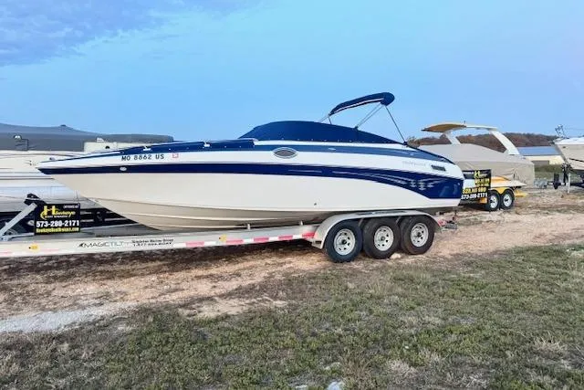 Slide: The Image of 2008 Crownline 270 BR boat on trailer, parked outdoors under a clear sky. - 2
