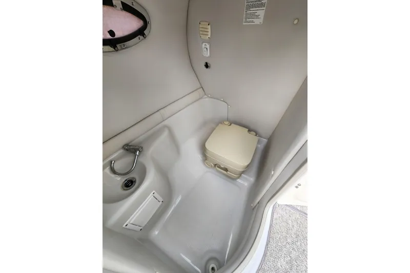 Slide: The Image of 2008 Crownline 270 BR boat interior bathroom with compact toilet and sink. - 20