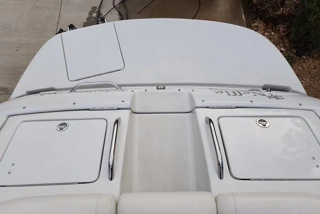 Slide: The Image of 2008 Crownline 270 BR boat deck with storage compartments and sleek design. - 22