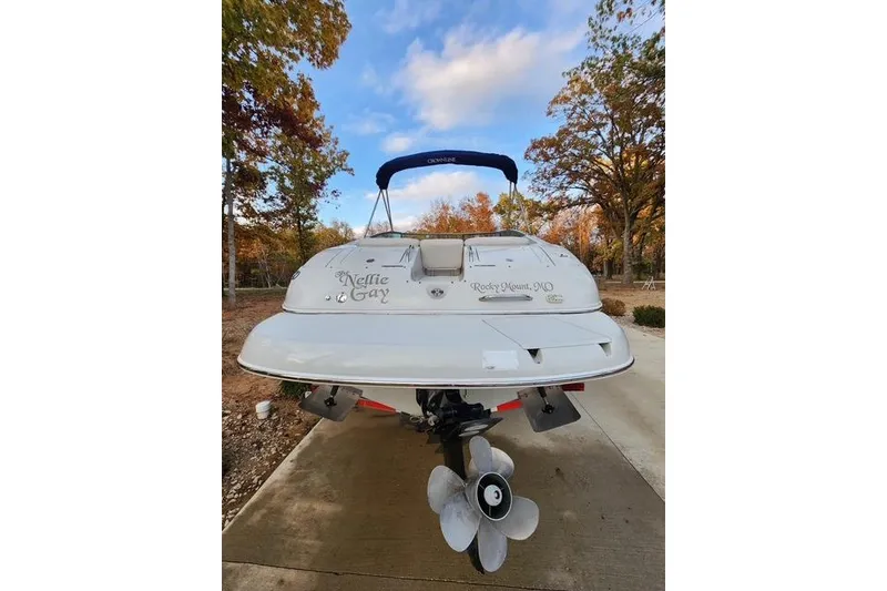 Slide: The Image of 2008 Crownline 270 BR boat with blue canopy, parked on a concrete path. - 3