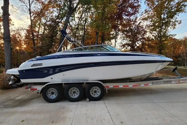 Slide: The Image of 2008 Crownline 270 BR boat on trailer, surrounded by autumn trees. - 4