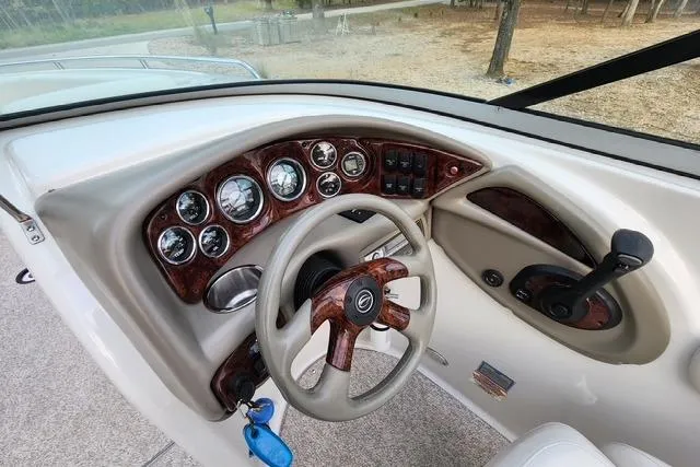Slide: The Image of 2008 Crownline 270 BR boat dashboard with wood accents and steering wheel. - 9