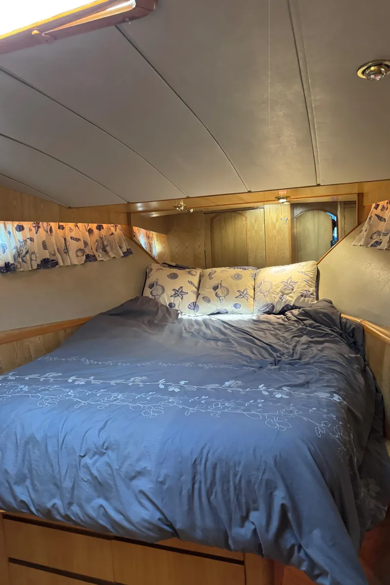 Slide: The Image of Cozy bedroom in 1991 Ocean Alexander 46 yacht with floral decor and wood paneling. - 14