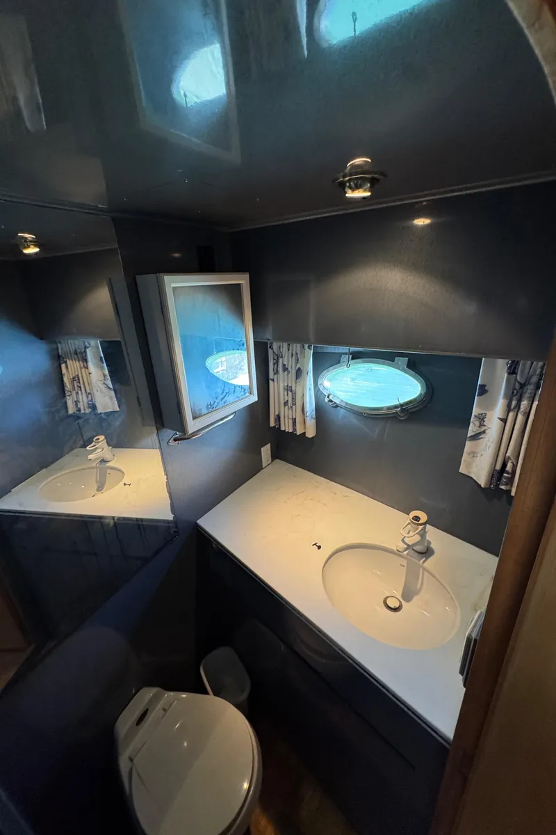 Slide: The Image of Bathroom interior of 1991 Ocean Alexander 46 yacht with porthole and modern fixtures. - 17