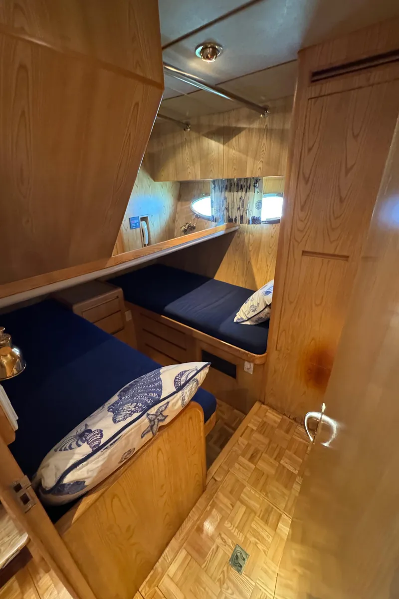 Slide: The Image of Cozy cabin interior of 1991 Ocean Alexander 46 yacht with wooden finish and twin beds. - 21