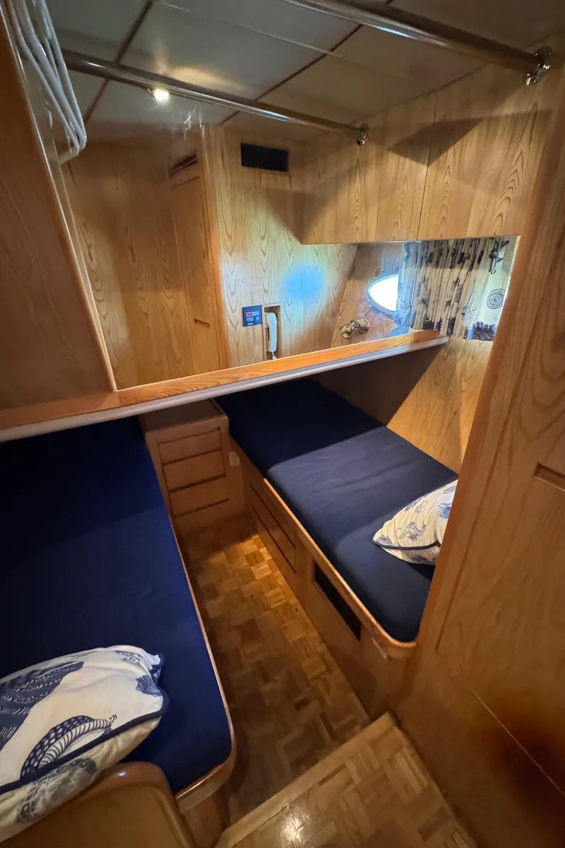 Slide: The Image of Cozy cabin interior of 1991 Ocean Alexander 46 yacht with twin beds and wooden finish. - 22