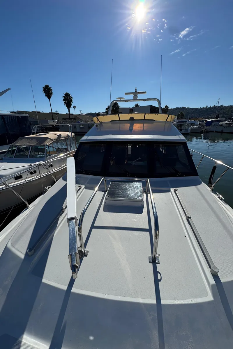 Slide: The Image of 1991 Ocean Alexander 46 yacht docked under clear blue sky. - 29