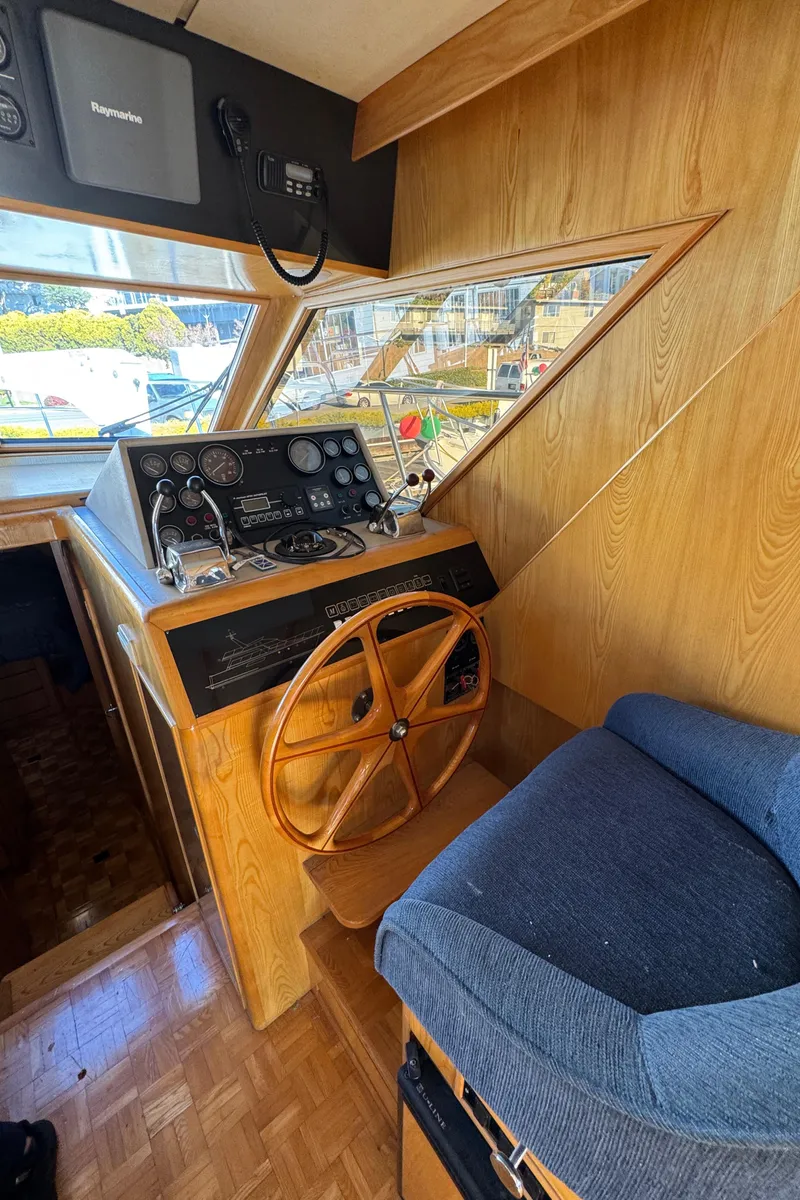 Slide: The Image of 1991 Ocean Alexander 46 yacht helm with wooden wheel and navigation instruments. - 41