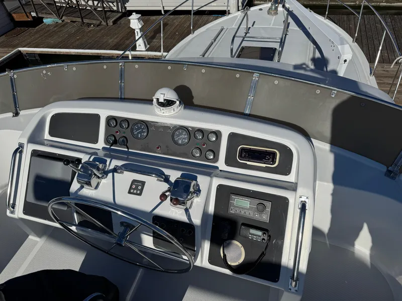 Slide: The Image of Cockpit view of 1991 Ocean Alexander 46 yacht with steering wheel and control panel. - 5