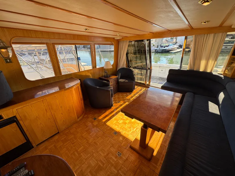 Slide: The Image of Luxurious 1991 Ocean Alexander 46 yacht interior with wood finishes and marina view. - 6