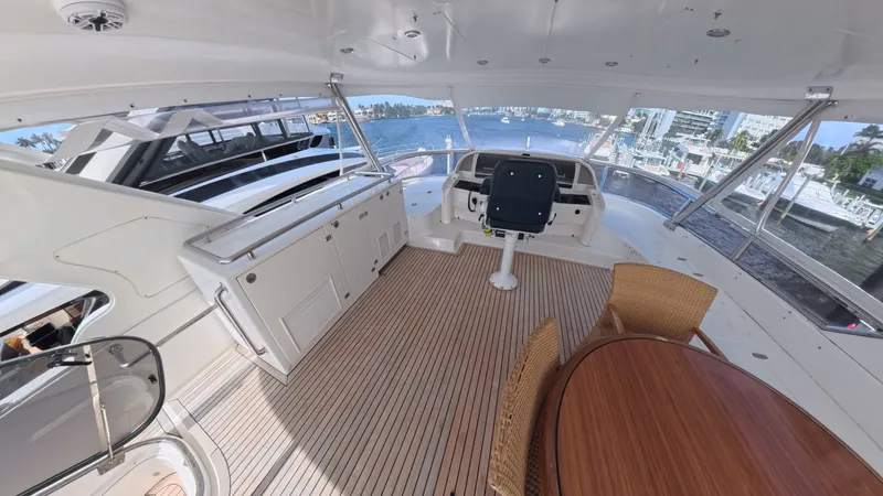 Slide: The Image of Luxurious 2009 Horizon Vision yacht interior with helm, seating, and waterfront view. - 2