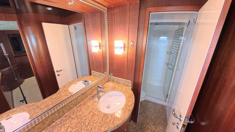 Slide: The Image of Luxurious yacht bathroom with granite countertop, wooden paneling, and glass shower door, Horizon Vision 2009. - 32