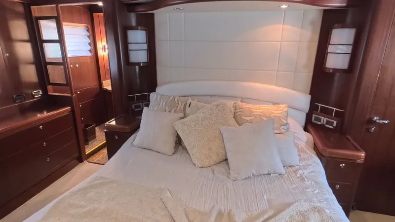 Slide: The Image of Luxurious yacht bedroom with plush pillows, wooden cabinetry, and soft lighting, Horizon Vision 2009 model. - 33