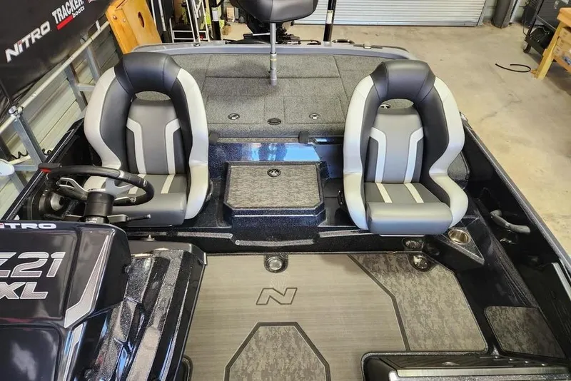 Slide: The Image of 2025 Nitro Z21 XL Pro boat interior with dual seats and steering console. - 10