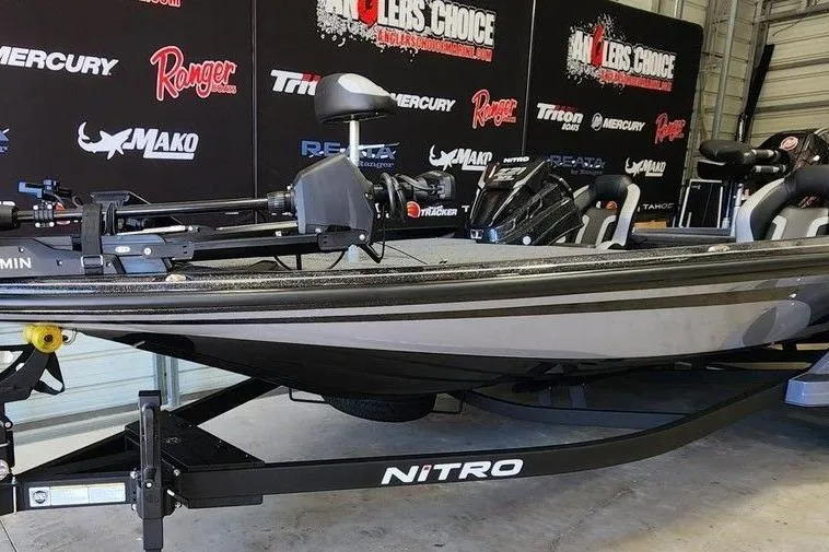 Slide: The Image of 2025 Nitro Z21 XL Pro boat on display in showroom with branded backdrop. - 3