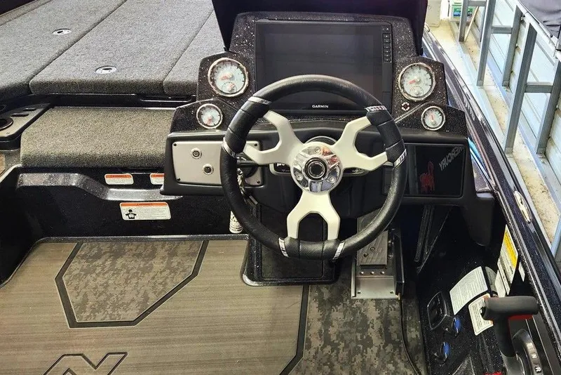 Slide: The Image of 2025 Nitro Z21 XL Pro boat cockpit with steering wheel and dashboard controls. - 5