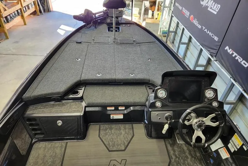 Slide: The Image of 2025 Nitro Z21 XL Pro boat interior with steering wheel and dashboard controls. - 9