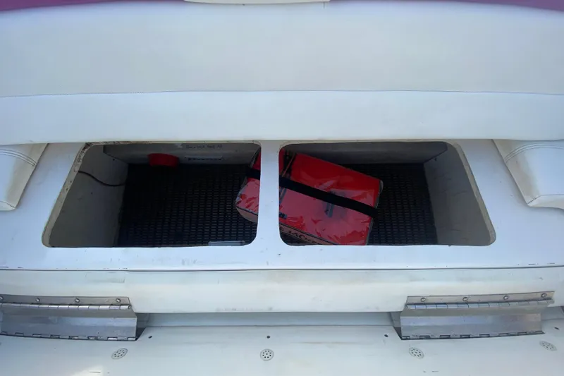 Slide: The Image of Storage compartment of 1999 Black Thunder XT 430 SC boat with red life jacket. - 10