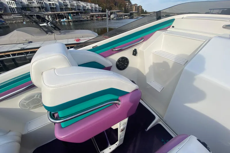 Slide: The Image of Interior of a 1999 Black Thunder XT 430 SC boat with colorful seating. - 11