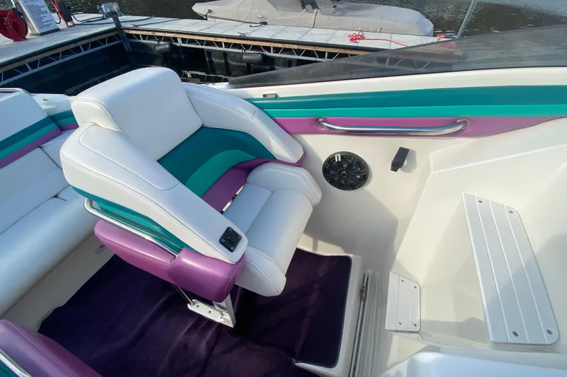 Slide: The Image of Interior of a 1999 Black Thunder XT 430 SC boat with colorful seating. - 13