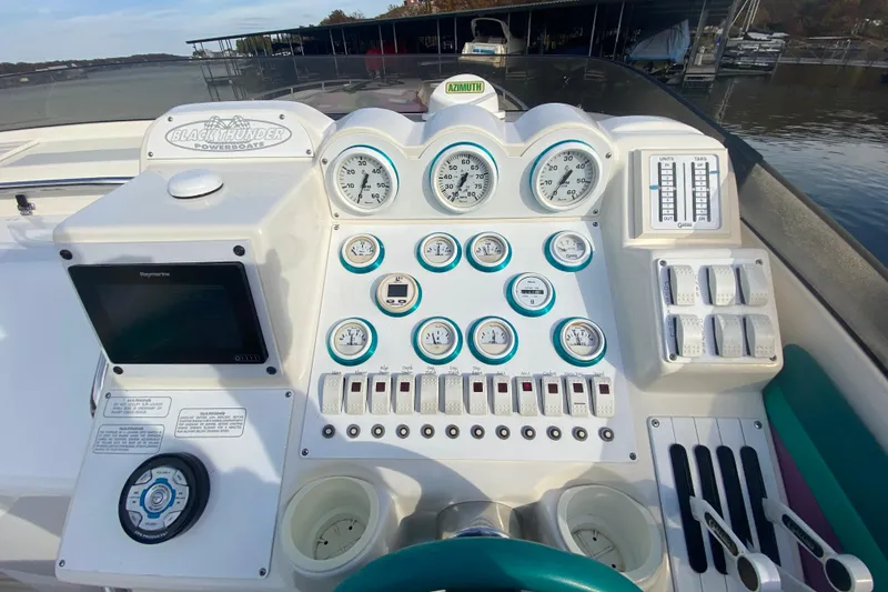 Slide: The Image of Control panel of a 1999 Black Thunder XT 430 SC powerboat with gauges and switches. - 21