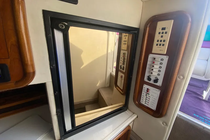 Slide: The Image of Interior of 1999 Black Thunder XT 430 SC boat with control panels and window. - 28