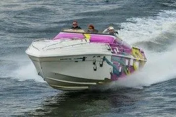 Slide: The Image of 1999 Black Thunder XT 430 SC speedboat with vibrant graphics cruising on water. - 3