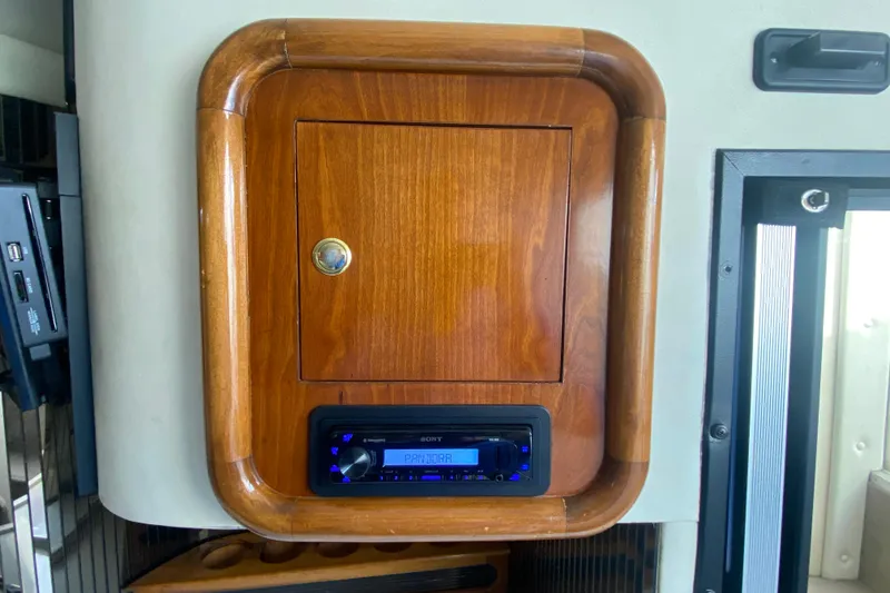 Slide: The Image of Wooden cabinet with a Sony stereo in a 1999 Black Thunder XT 430 SC boat. - 30