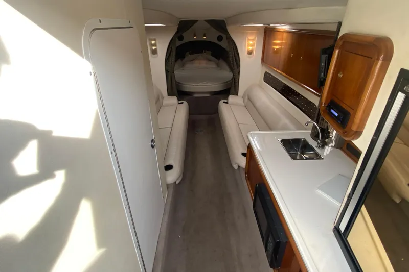 Slide: The Image of Interior of a 1999 Black Thunder XT 430 SC boat with kitchenette and seating area. - 31