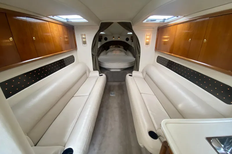 Slide: The Image of Luxurious interior of 1999 Black Thunder XT 430 SC boat with leather seating and wood cabinets. - 32