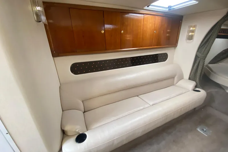 Slide: The Image of Interior of 1999 Black Thunder XT 430 SC with white leather sofa and wooden cabinets. - 33