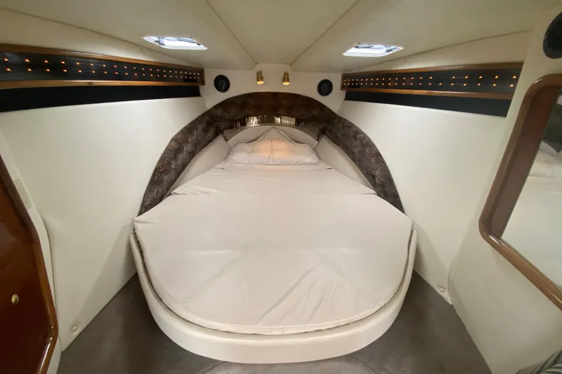 Slide: The Image of Luxurious cabin interior of 1999 Black Thunder XT 430 SC boat with cozy bed. - 35