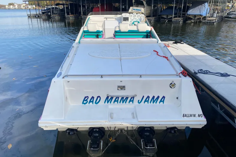 Slide: The Image of 1999 Black Thunder XT 430 SC boat named "Bad Mama Jama" docked at a marina. - 4