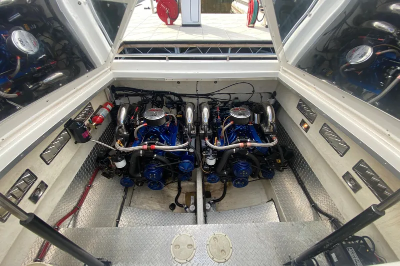 Slide: The Image of Engine compartment of a 1999 Black Thunder XT 430 SC boat, showcasing dual engines. - 43