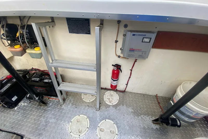 Slide: The Image of Interior of 1999 Black Thunder XT 430 SC boat with ladder, fire extinguisher, and equipment. - 48